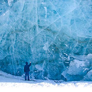 boy touching wall of ice